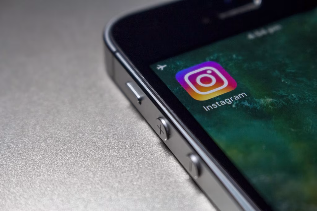 Close-up shot of an iPhone displaying the Instagram app icon, indicating the platform's availability for users in the Philippines to enjoy music and Reels features. - midnightrebels.com