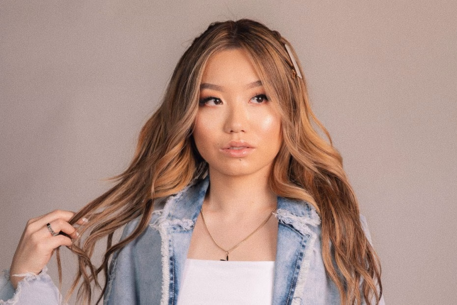 CHYL, a young woman with blonde-highlighted hair and a denim jacket, gazes thoughtfully in a promotional photo for her song "Barbie" featuring Melissa Brooks. - midnightrebels.com