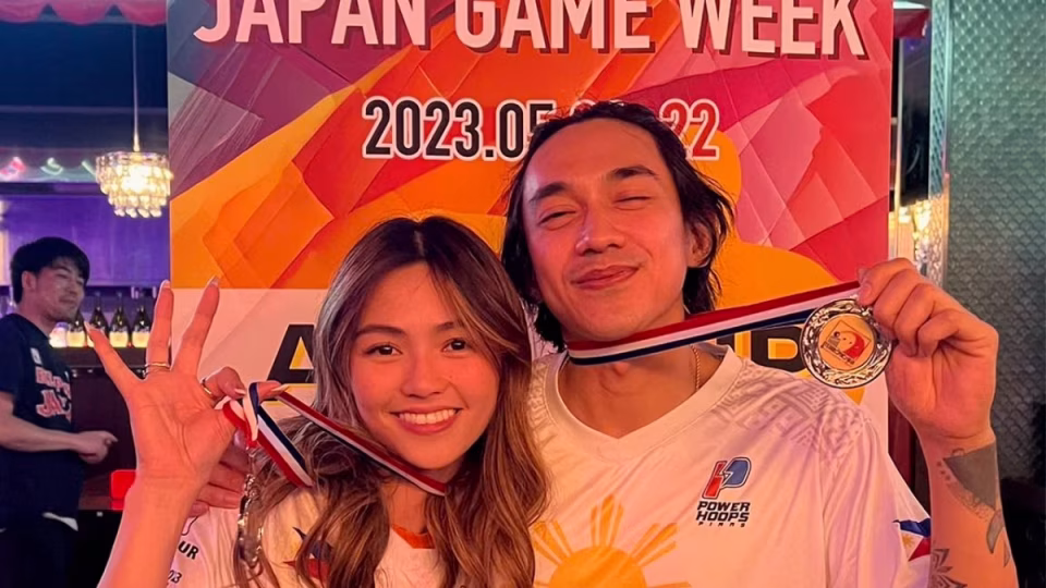 DJ Jaro Cab and Emcy Grey proudly display their medals, representing the Philippines at Japan Game Week 2023. - midnightrebels.com