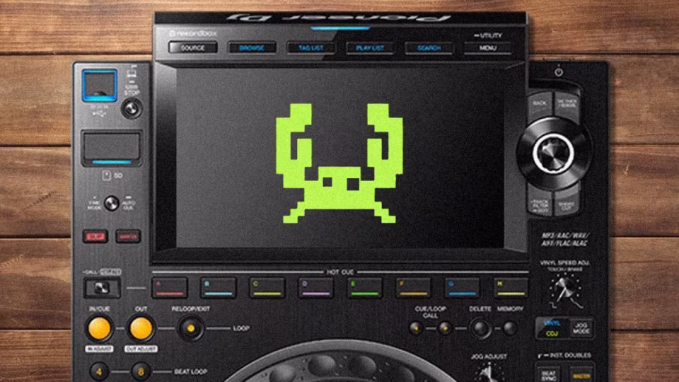 A Pioneer DJ controller displays a pixelated green crab icon on its screen, symbolizing 'crab mentality' within the Philippine DJ culture, set against a wooden background. - midnightrebels.com