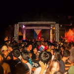 A large, diverse crowd of people is packed into "The Plug" nightclub in Danao, Cebu, with a stage featuring a Philippine flag in the background, highlighting the venue's vibrant nightlife scene. - midnightrebels.com