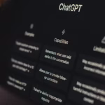 A close-up shot shows a computer screen displaying ChatGPT's capabilities and limitations, including its ability to remember conversation history and decline inappropriate requests, suggesting AI's potential impact on content creation. - midnightrebels.com