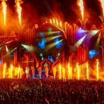 Tomorrowland music festival stage with flames and crowd.