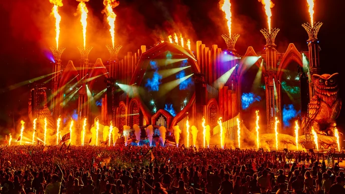 Tomorrowland music festival stage with flames and crowd.