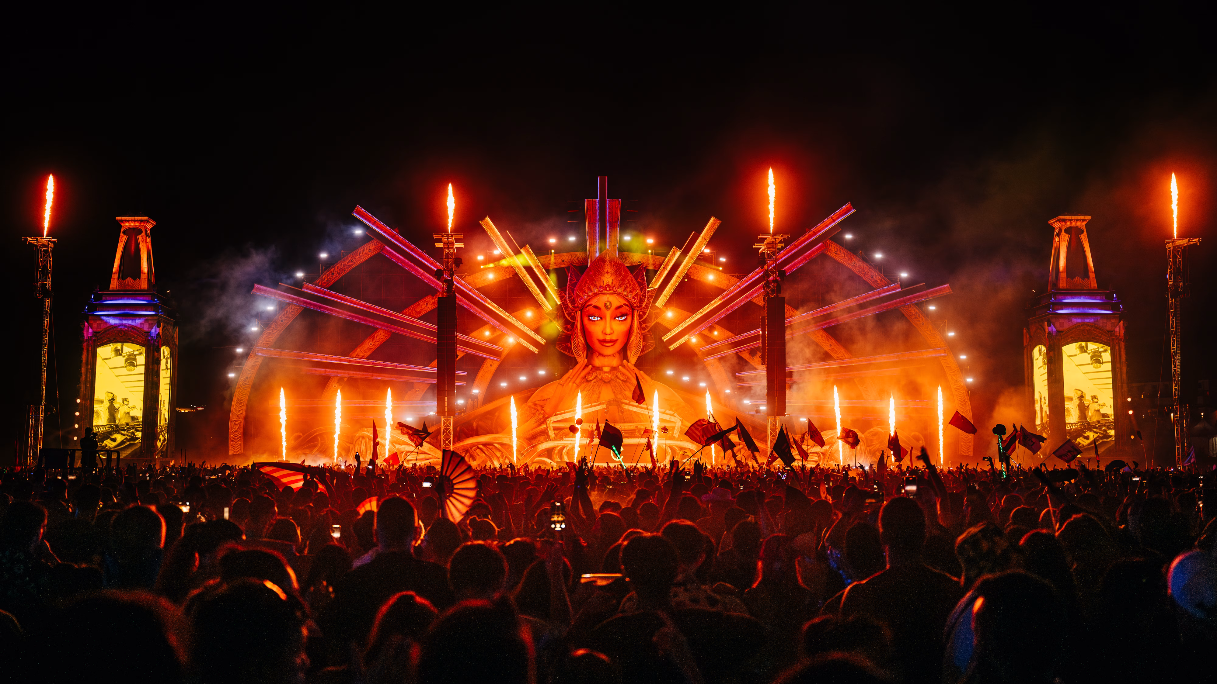 Large crowd at EDC Thailand with stage, lights, and fire.