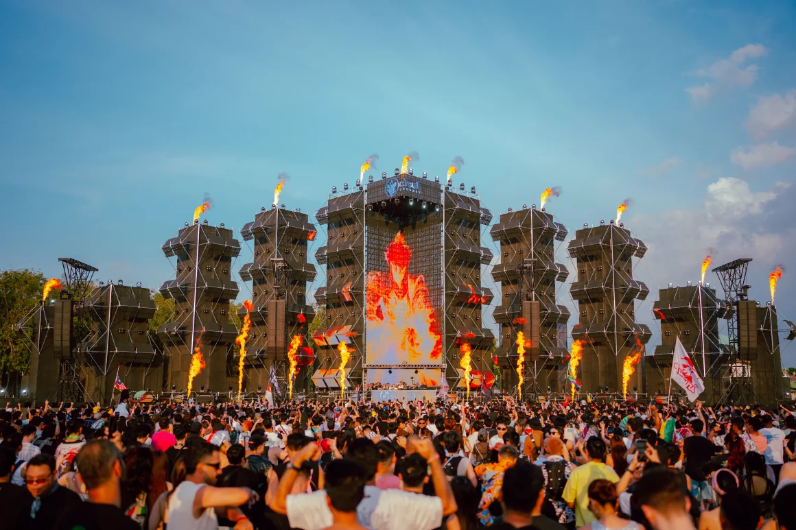 Crowd at Circuit Grounds festival stage with fire and EDM music.