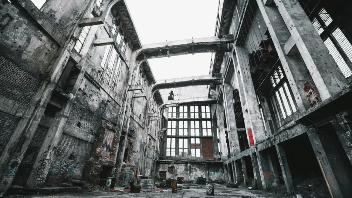 Abandoned industrial building interior with brick and concrete details.