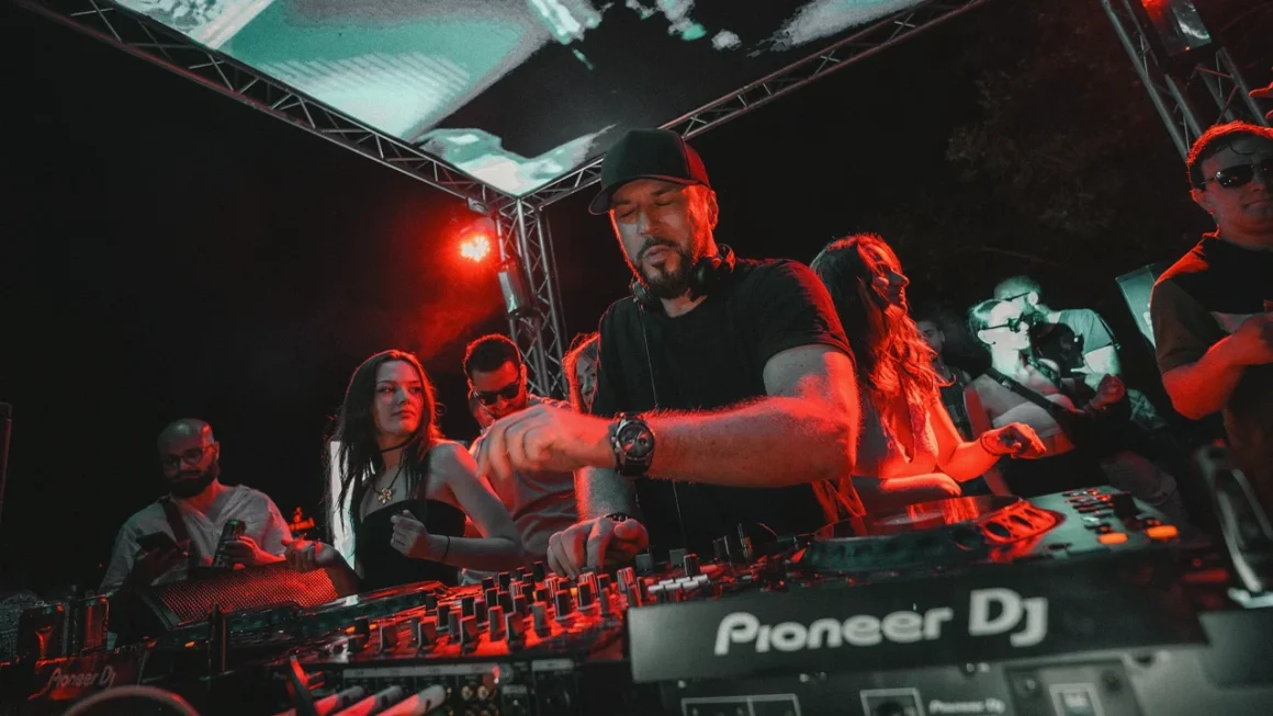 DJs performing at nightclub event with Pioneer DJ equipment and red cyan stage lighting