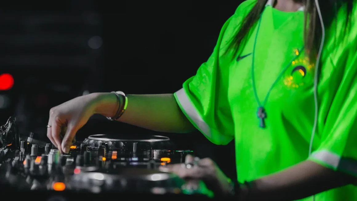 DJ playing electronic music on turntables at nightclub event for exposure