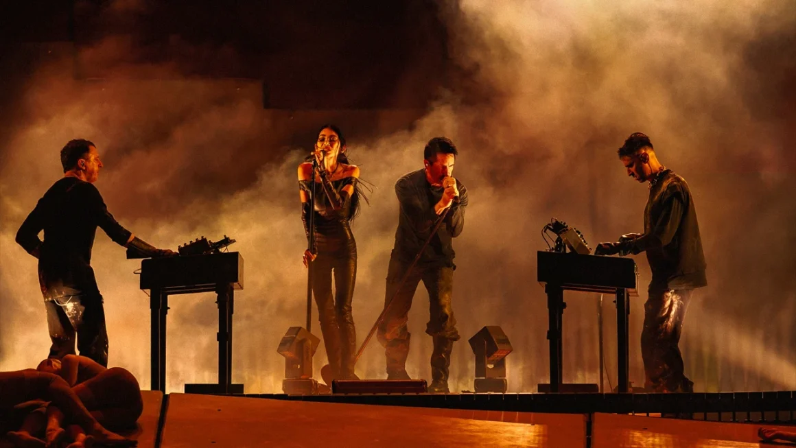Nine Inch Noize performing on stage with dramatic orange lighting and smoke effects