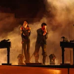 Nine Inch Noize performing on stage with dramatic orange lighting and smoke effects