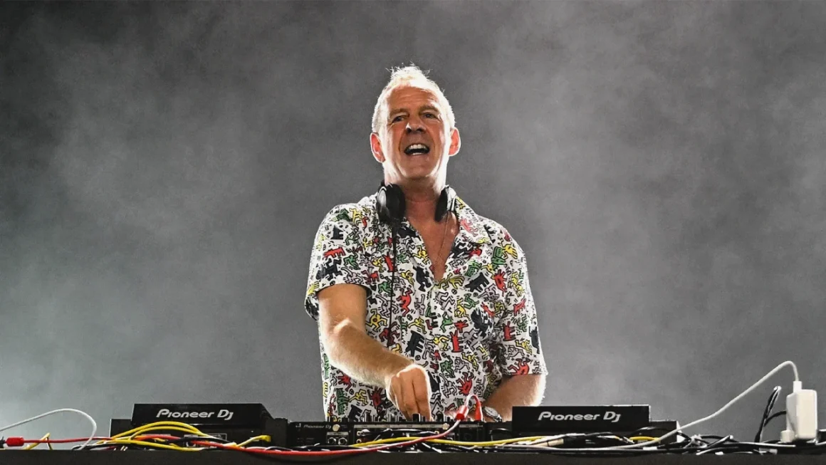 Energetic DJ mixing music on Pioneer equipment at a live concert.