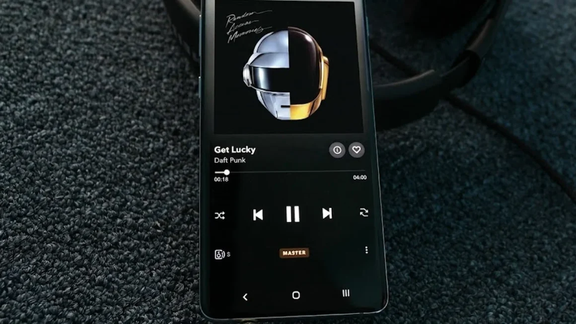 Smartphone playing Daft Punk "Get Lucky" with album art and headphones.