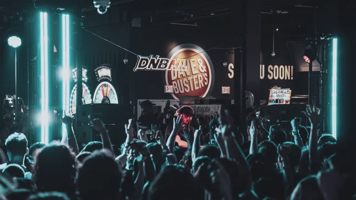 Energetic crowd and DJ at a vibrant Dave & Buster's live music event.