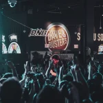 Energetic crowd and DJ at a vibrant Dave & Buster's live music event.