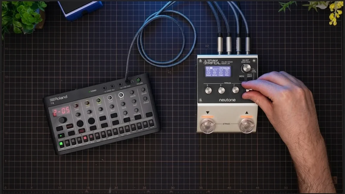 Hand adjusting Neutone RFDL audio processor beside Roland T-8 beat machine.
