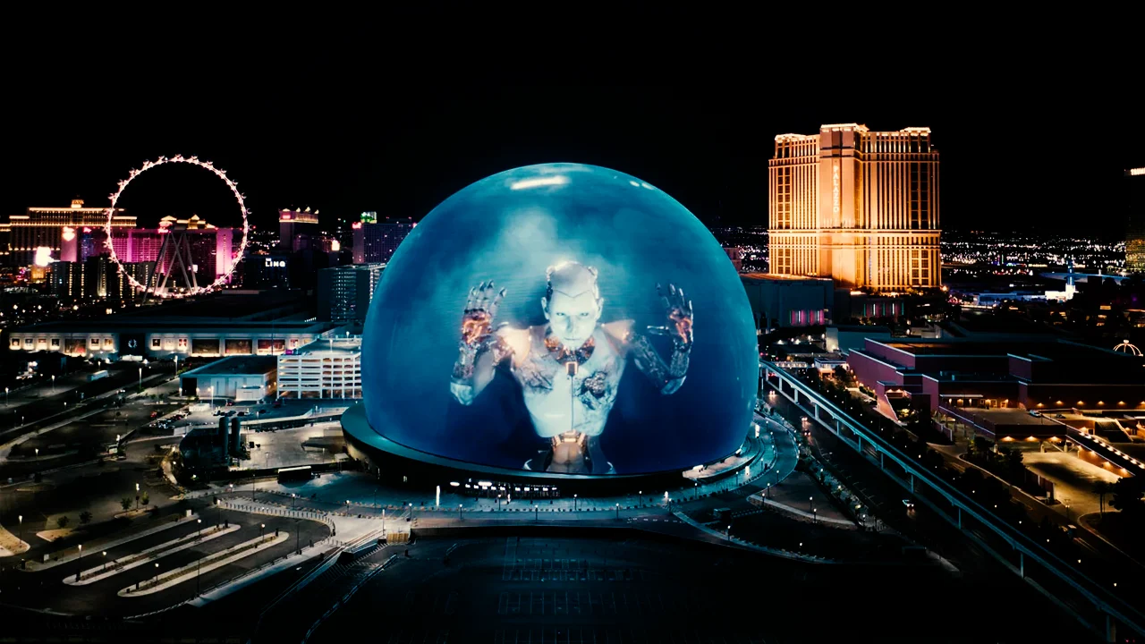 Panoramic night view of Las Vegas Sphere with giant robot display at night.