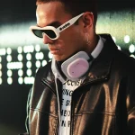 Hoest, DJ, Producer Stylish man with white sunglasses and pink Nothing headphones, black leather jacket.